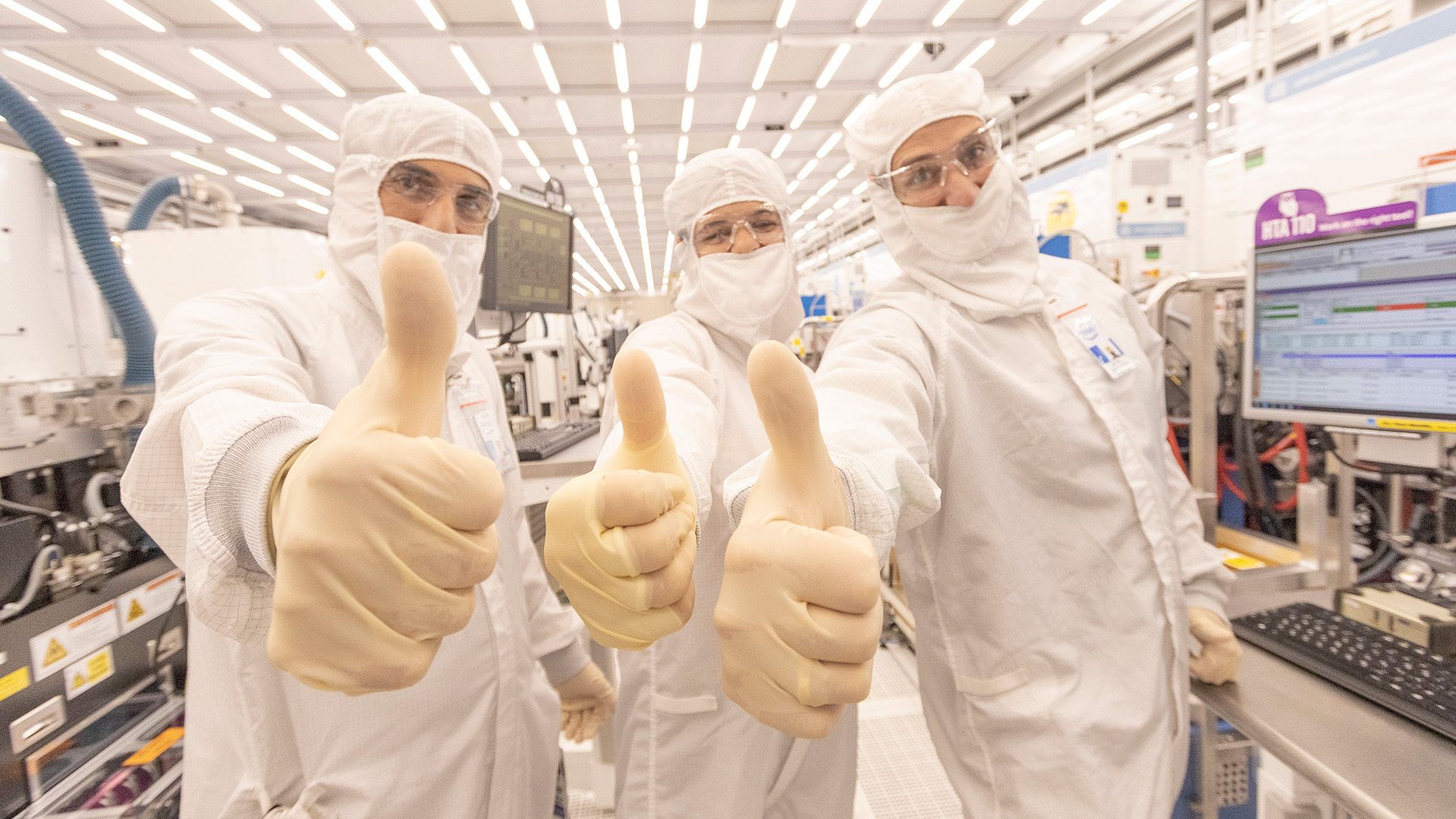 Three engineers give a thumbs up inside Intel&#039;s Fab 28.